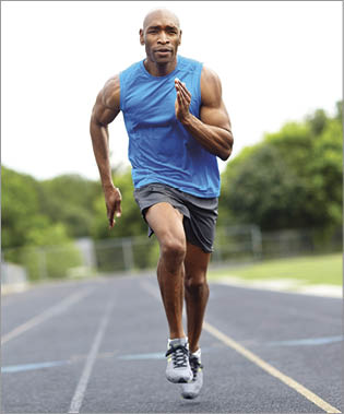 Full length portrait of a male runner sprinting on the race track