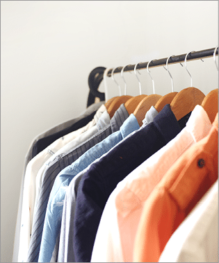 Open wardrobe is usually adapted for a small living space  The shirts  dresses or coats are hanged on a clothing rail  and some shelving at the bottom 