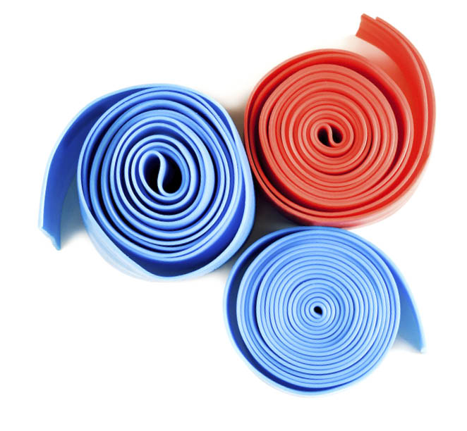 Set of different resistance bands for fitness on white background