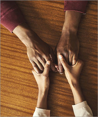 Closeup shot of two unrecognizable people holding hands in comfort