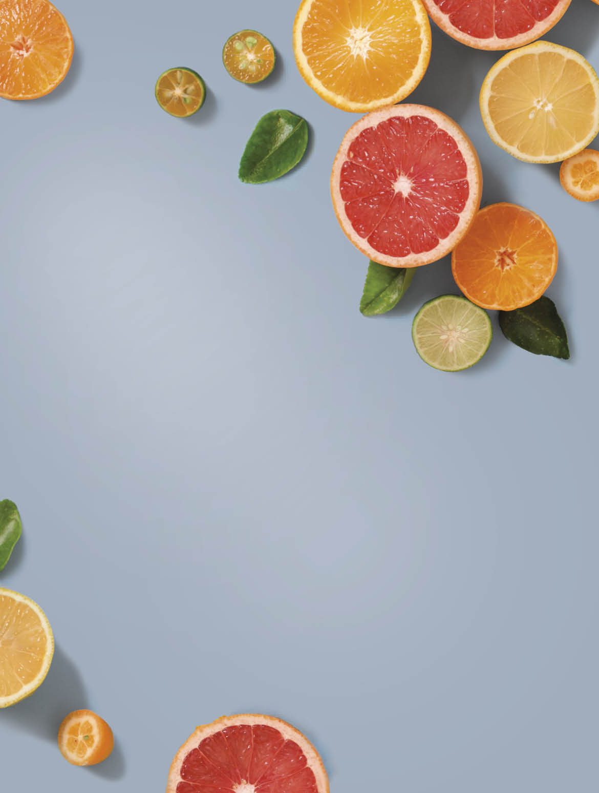 Sliced various citrus fruits on blue background 