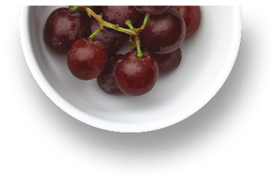 A grouping of various super foods  Blueberries, chia, apples, grapes, spinach, tomatoes, grapes, cashews, pepitas, sunflower seeds, walnuts, kiwi, oatmeal