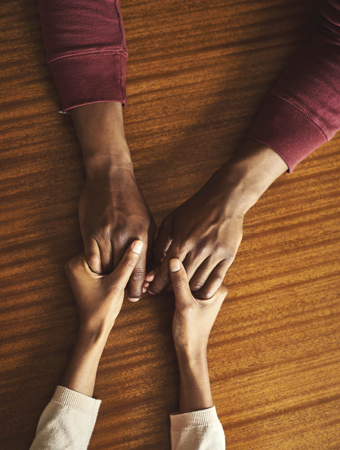 Closeup shot of two unrecognizable people holding hands in comfort