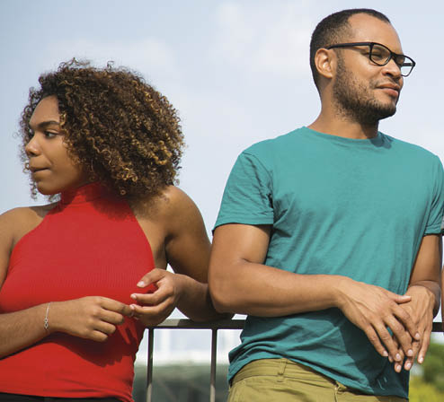 Team of friends enjoying outdoor walk  Mix raced group of young people standing on bridge outdoors, leaning on railing, talking, chatting  Team of friends concept