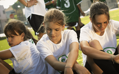Footballers  12-14  on pitch  other team celebrating in background