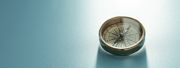 Compass leading to success  On background with copy space 