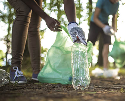Unrecognizable people cleaning up the park from garbage